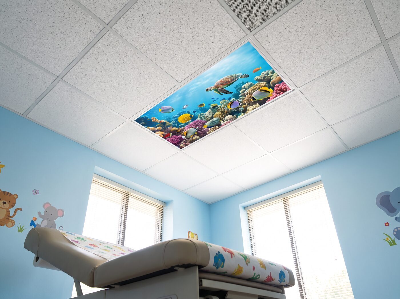 Pediatric exam room with a coral reef ocean light cover in the drop ceiling